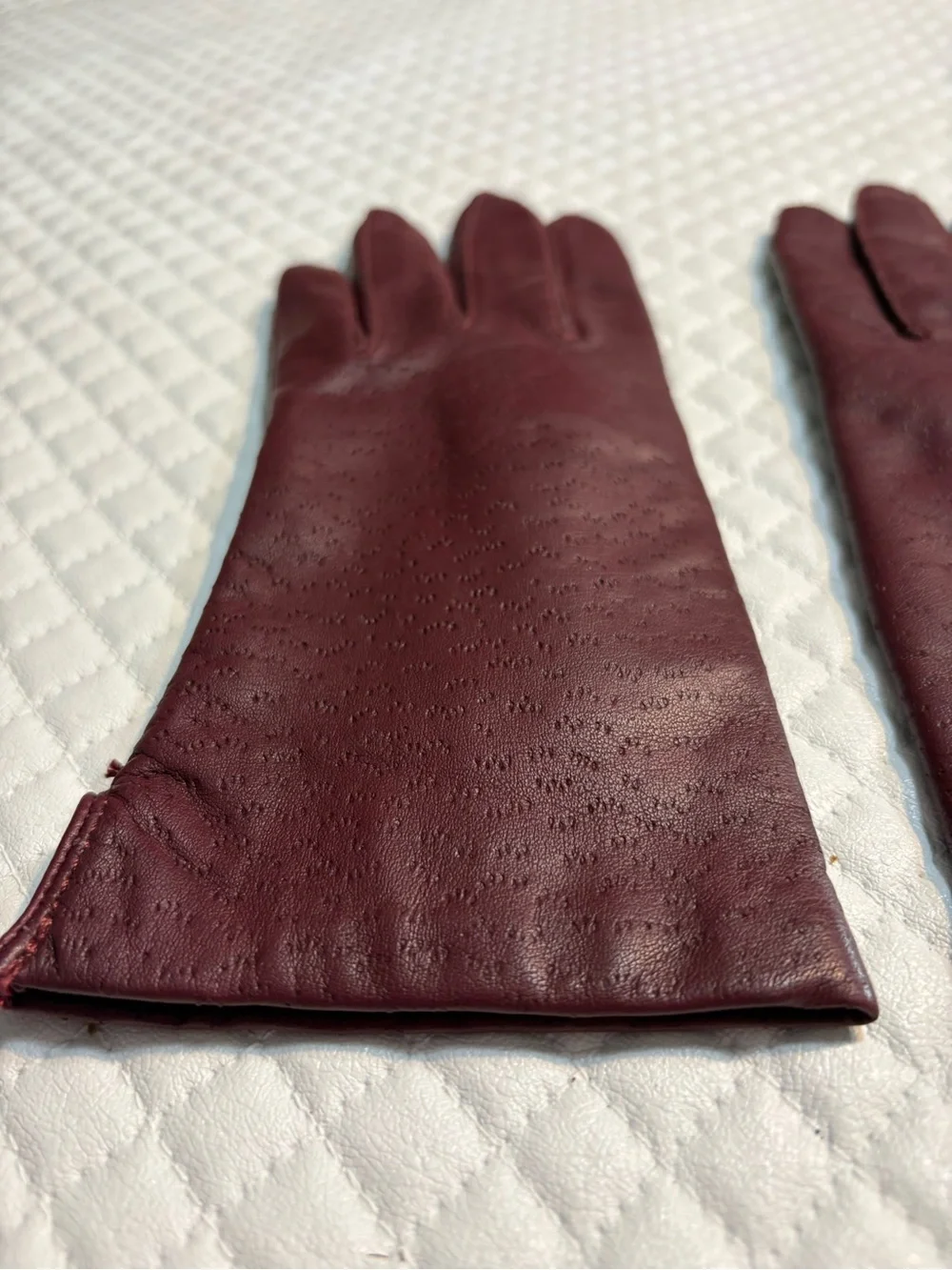 maroon leather gloves feature a distinctive textured perforated pattern 6.5
